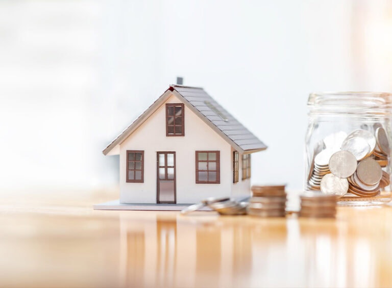 House Model With Coins Saving Concept