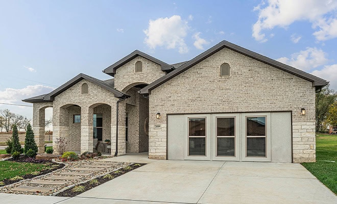 New Construction Light Brick Home Arched Entry