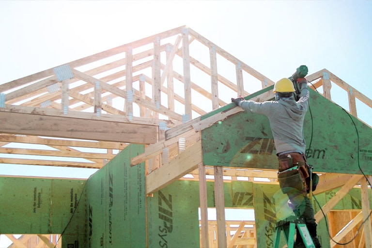 Roofer Installing Sheathing New Home Frame Safety Gear